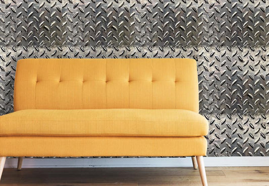 Diamond plate peel and stick wallpaper pattern on wall with yellow sofa on wood floor with white baseboard