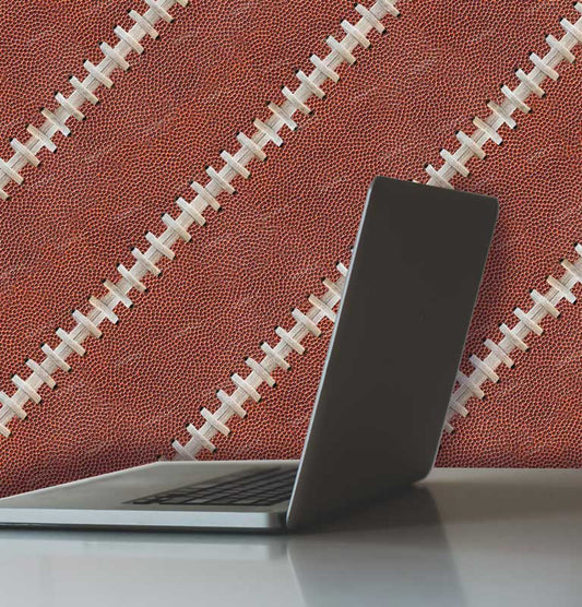 Football leather with laces wallpaper pattern with laptop and desk