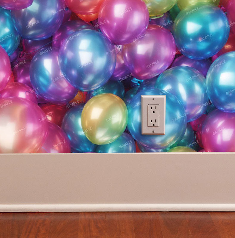 Colorful party balloons removable wallpaper pattern on wall with outlet trim and wood floor