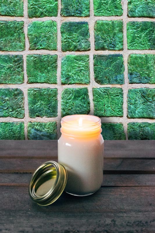 Vintage Jade Tile wallpaper pattern on wall with candle in jar